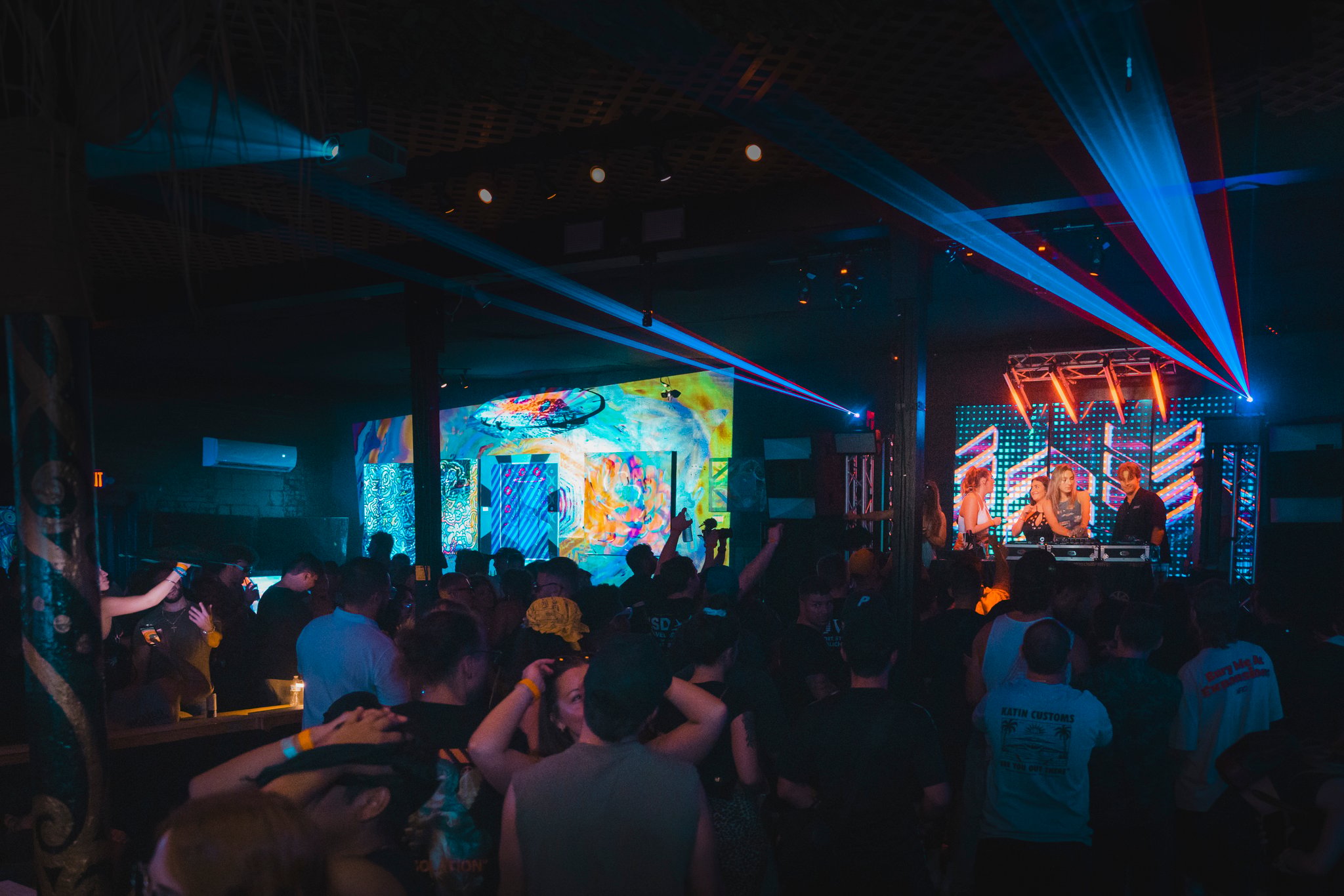 Mad Chiller World gathering with a crowd, stage, and colorful laser lighting.